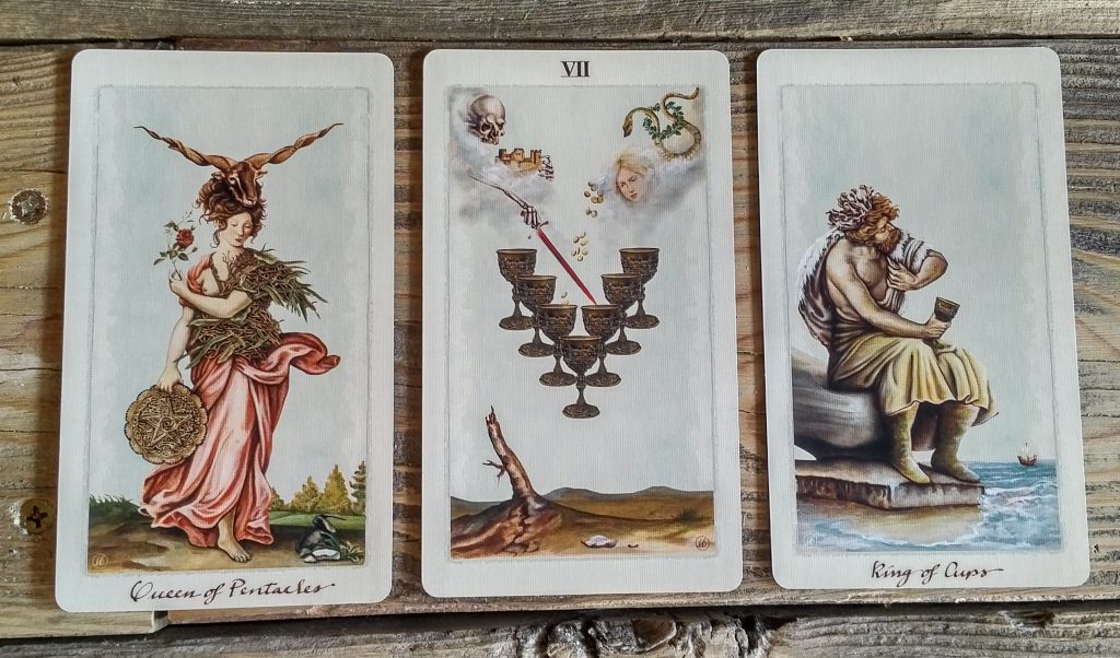 Uusi Pagan Otherworlds Tarot, with the Queen of Pentacles, 7 of Cups, and King of Cups